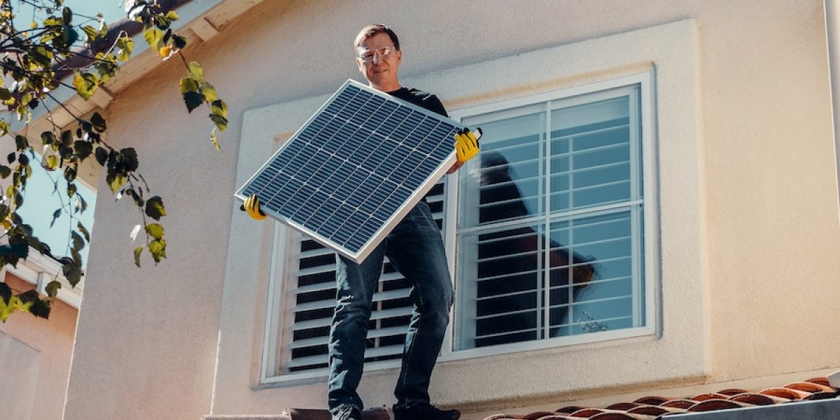 A Man Holding a Solar Panel